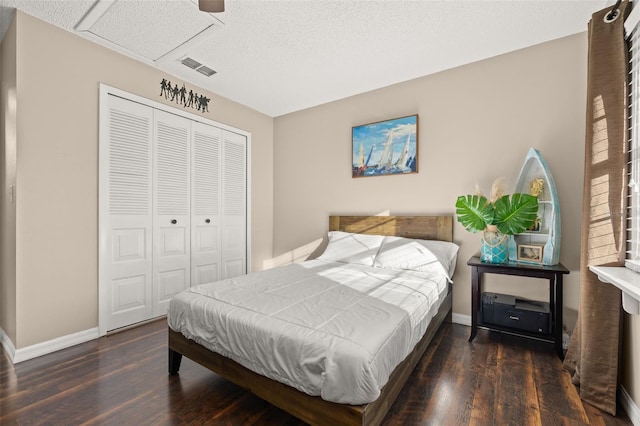 bedroom with ceiling fan, a closet, and dark hardwood / wood-style flooring