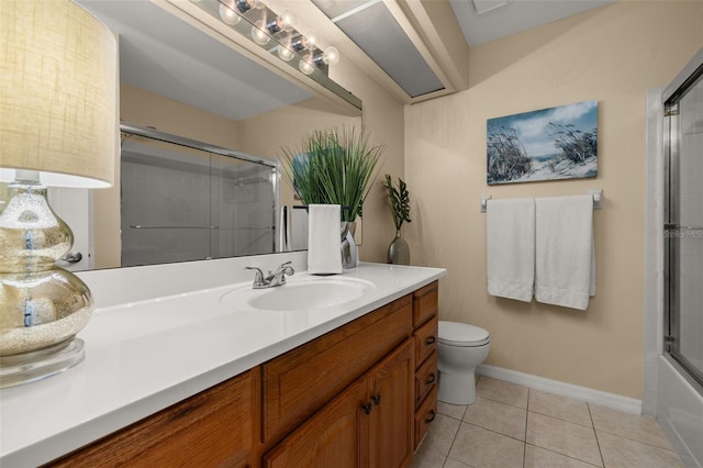 full bathroom featuring toilet, tile patterned flooring, enclosed tub / shower combo, and vanity