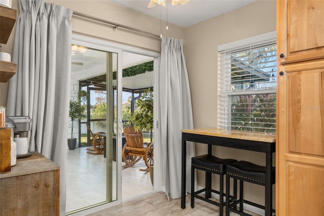 doorway to outside featuring ceiling fan