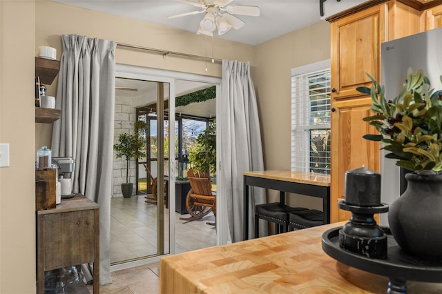 tiled dining area with ceiling fan