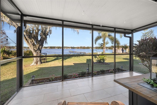 unfurnished sunroom with a water view