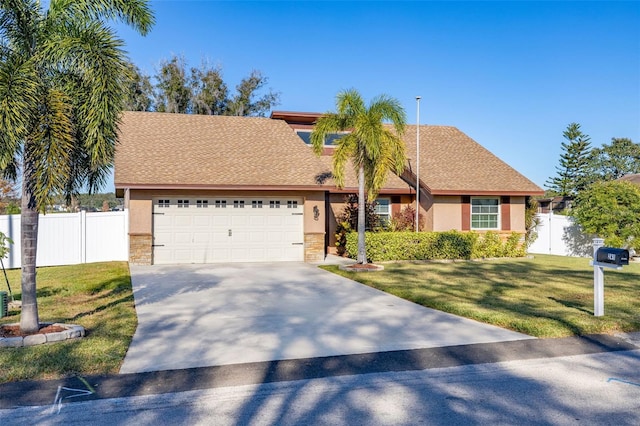 view of front facade with a front yard and a garage