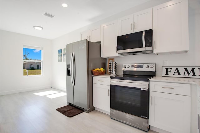 kitchen with white cabinetry, light hardwood / wood-style floors, and appliances with stainless steel finishes