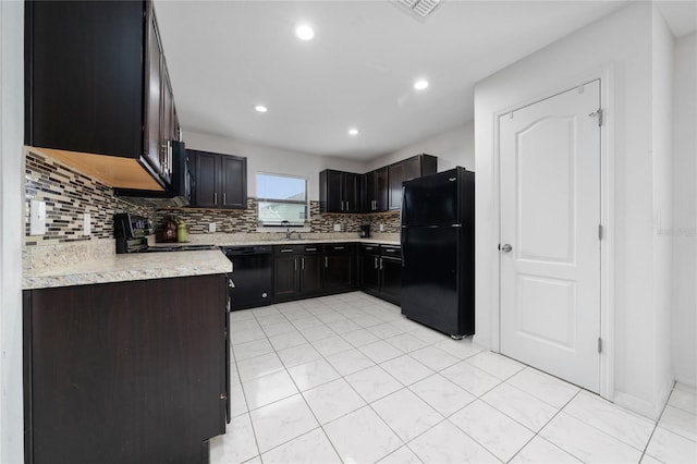 kitchen with black appliances, light tile patterned floors, decorative backsplash, and dark brown cabinetry