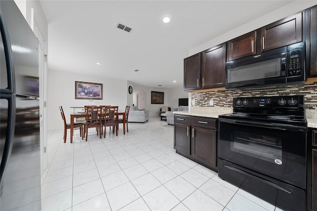 kitchen with decorative backsplash, light tile patterned floors, dark brown cabinetry, and black appliances