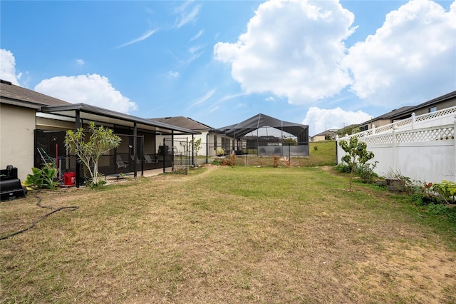 view of yard featuring glass enclosure