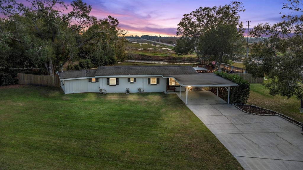 view of front of house with a lawn and a carport