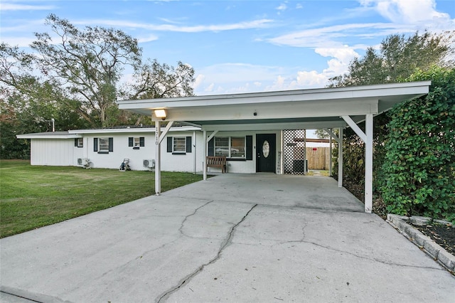 view of front of house with a front lawn and a carport