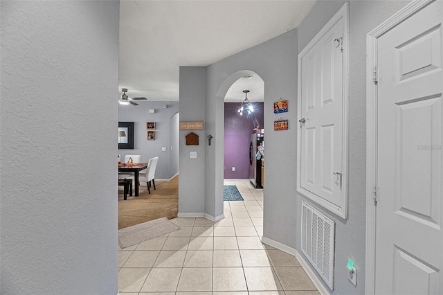 hall featuring light tile patterned floors