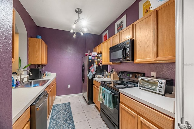 kitchen with black appliances, sink, hanging light fixtures, a chandelier, and light tile patterned floors