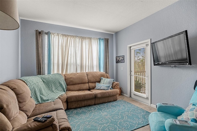 carpeted living room with a textured ceiling