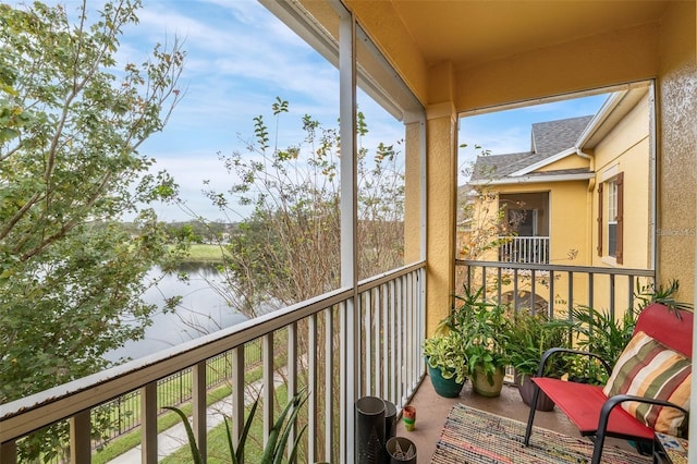 balcony featuring a water view