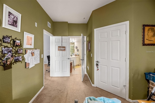 hall featuring light colored carpet