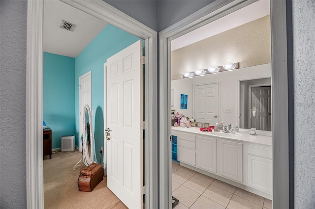 bathroom featuring tile patterned flooring and vanity