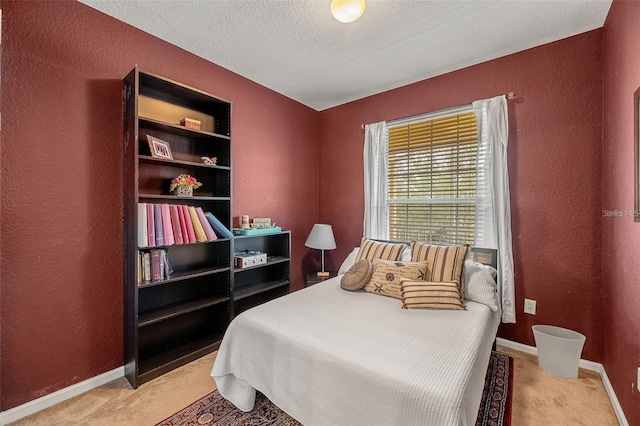 bedroom with a textured ceiling and light carpet