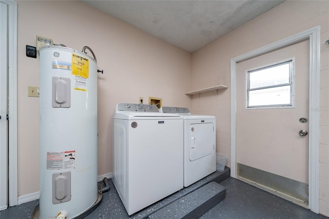 laundry room with water heater and washer and clothes dryer