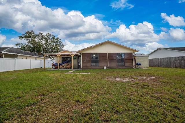 rear view of property featuring a lawn and a patio