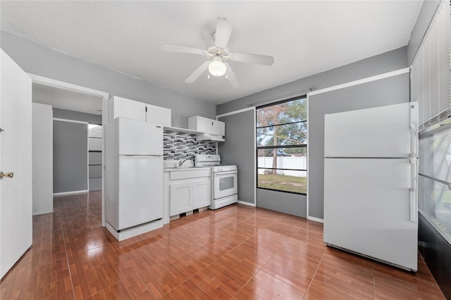 kitchen featuring sink, backsplash, white appliances, ceiling fan, and white cabinets