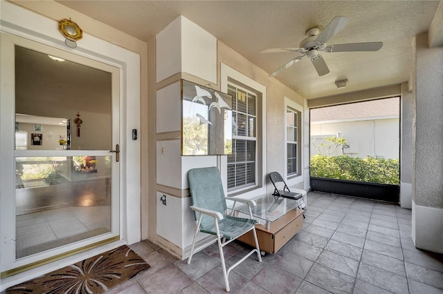 sunroom featuring ceiling fan