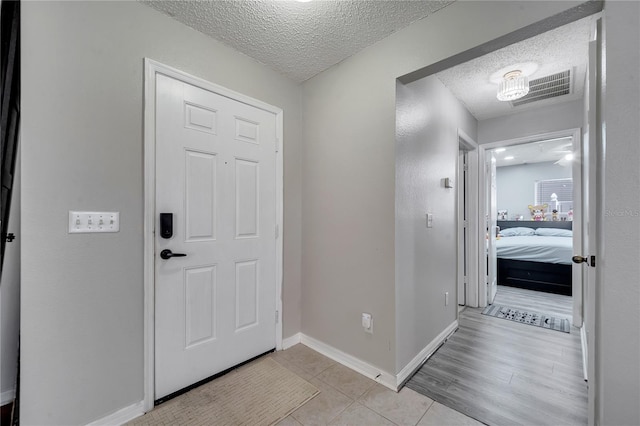 tiled foyer featuring a textured ceiling