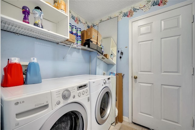 laundry area with washer and dryer and a textured ceiling