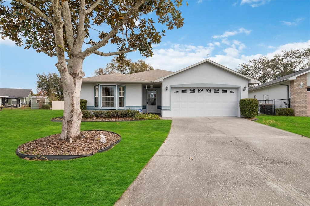 ranch-style house with a front lawn and a garage