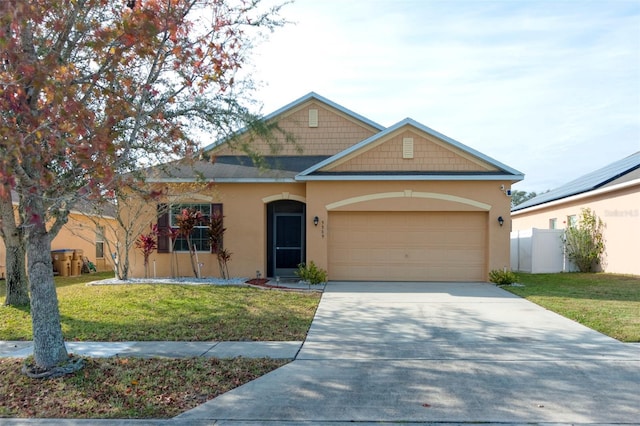 view of front of property with a garage and a front lawn