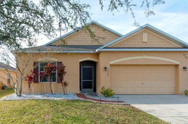 view of front of home with a front yard and a garage