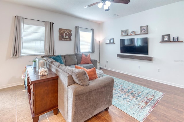 living room with ceiling fan and light hardwood / wood-style floors