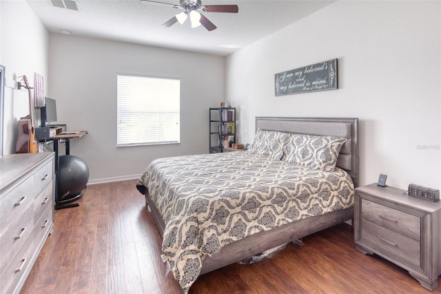 bedroom with ceiling fan and dark hardwood / wood-style floors