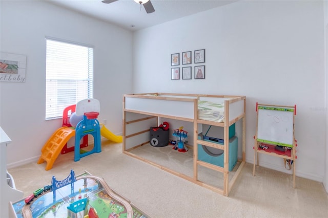 carpeted bedroom featuring multiple windows and ceiling fan