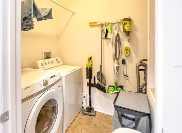 laundry area featuring separate washer and dryer and light tile patterned flooring