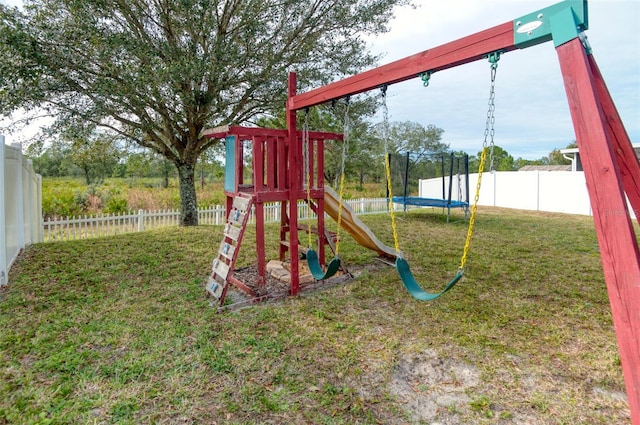 view of playground featuring a yard and a trampoline