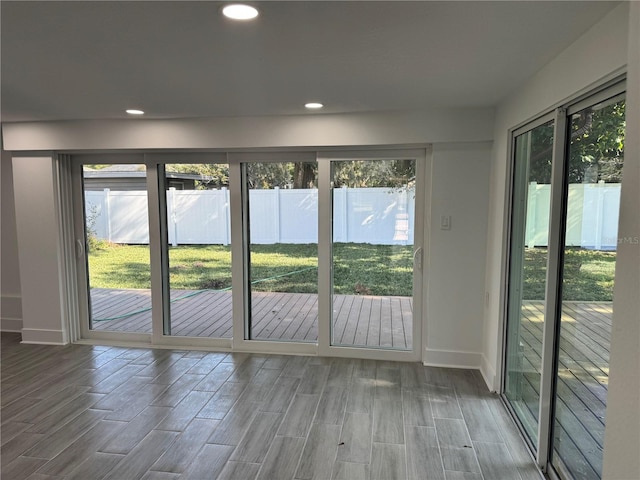 doorway featuring a wealth of natural light, recessed lighting, and wood tiled floor