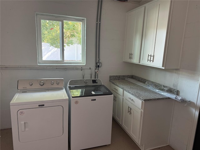 washroom with cabinet space and independent washer and dryer