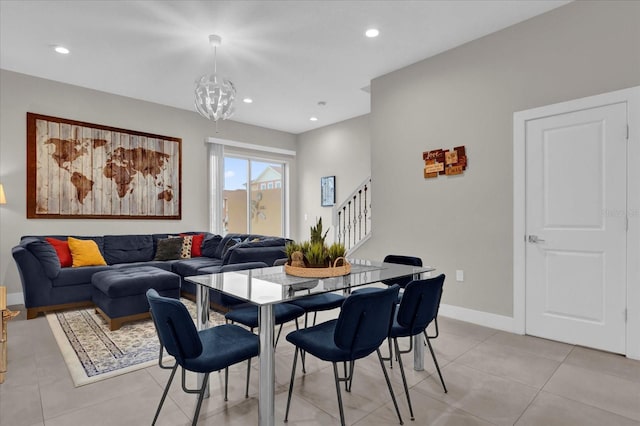 tiled dining room featuring a notable chandelier