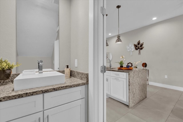 bathroom with lofted ceiling, vanity, and tile patterned floors