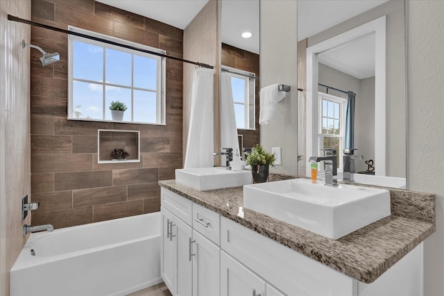 bathroom featuring vanity and shower / bathtub combination with curtain