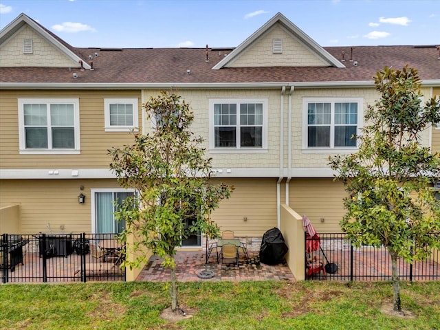 rear view of house featuring a yard and a patio