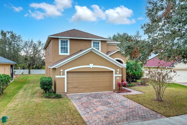 view of property with a front yard and a garage