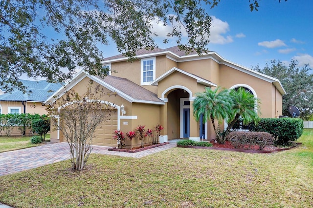 view of front facade with a front yard and a garage