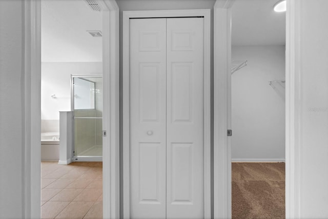 hall featuring light tile patterned flooring