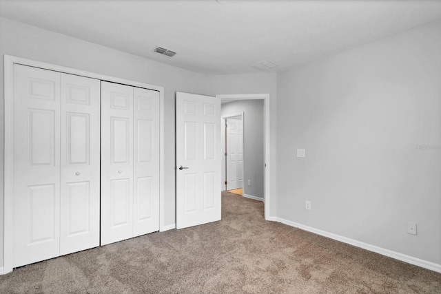 unfurnished bedroom featuring carpet flooring and a closet