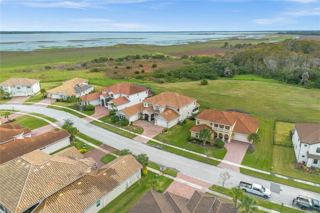 birds eye view of property featuring a water view and a residential view