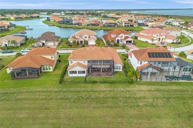 birds eye view of property featuring a water view and a residential view