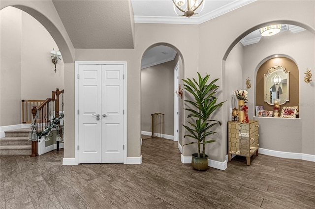 entrance foyer with baseboards, stairs, ornamental molding, and wood finished floors