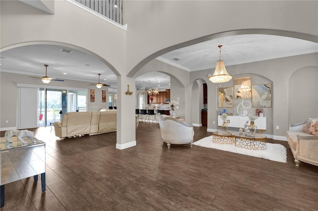 living area with ornamental molding, wood finished floors, and baseboards