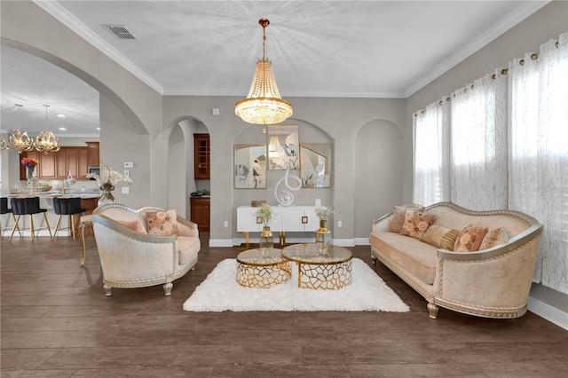 living room with ornamental molding, visible vents, and baseboards