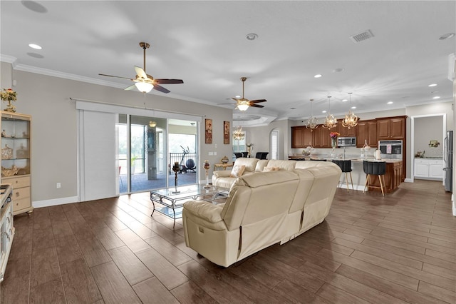 living area with dark wood-style floors, ornamental molding, visible vents, and recessed lighting