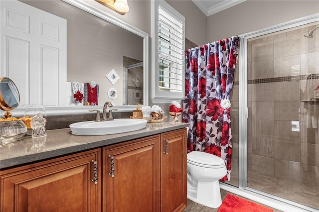 full bath featuring toilet, a stall shower, crown molding, and vanity